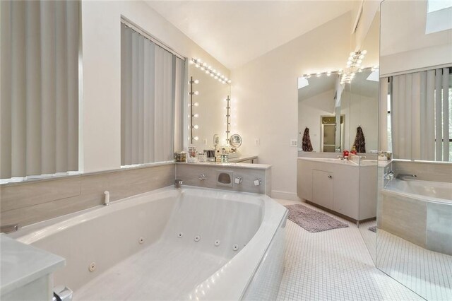 3213 Tolmas Dr, Metairie, LA 70002 - bathroom featuring vaulted ceiling, a whirlpool tub, vanity, and tile patterned floors