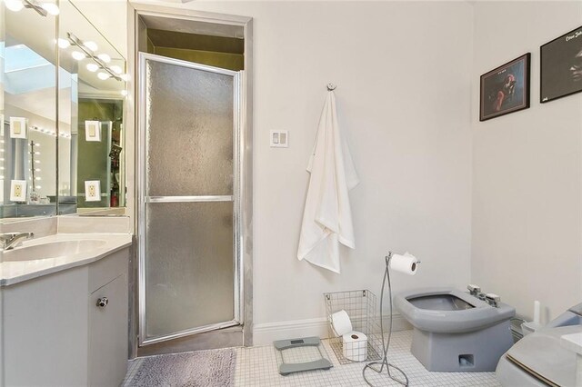 3213 Tolmas Dr, Metairie, LA 70002 - bathroom with vanity, toilet, a shower stall, a bidet, and tile patterned flooring