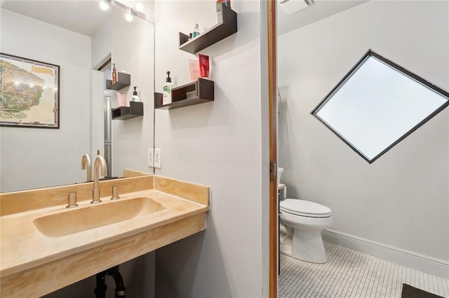 3213 Tolmas Dr, Metairie, LA 70002 - bathroom featuring tile patterned floors, toilet, baseboards, and vanity
