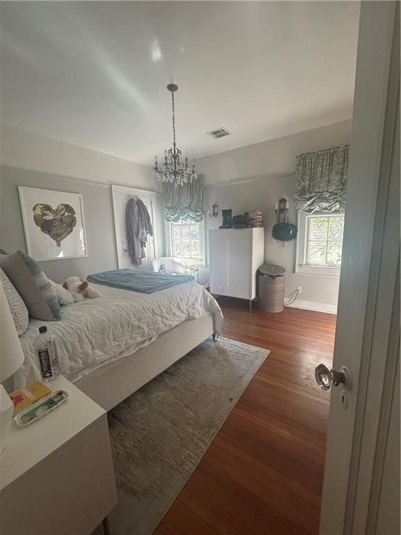 1222 Broadway St, New Orleans, LA 70118 - bedroom featuring a chandelier, wood finished floors, and baseboards