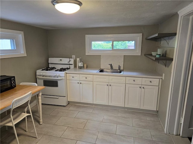 1222 Broadway St, New Orleans, LA 70118 - kitchen featuring gas range gas stove, a sink, healthy amount of natural light, and light countertops