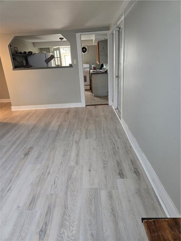 1222 Broadway St, New Orleans, LA 70118 - unfurnished living room featuring wood finished floors and baseboards