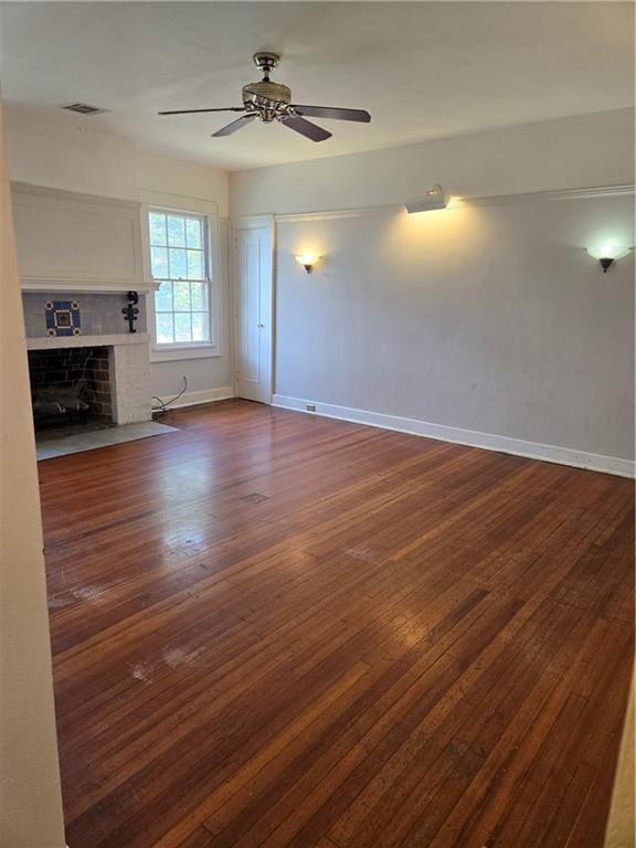 1222 Broadway St, New Orleans, LA 70118 - unfurnished living room featuring dark wood-type flooring, a ceiling fan, baseboards, and a tile fireplace