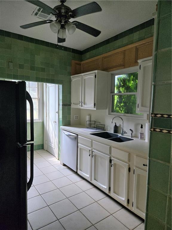 1222 Broadway St, New Orleans, LA 70118 - kitchen featuring freestanding refrigerator, stainless steel dishwasher, a sink, light countertops, and a ceiling fan