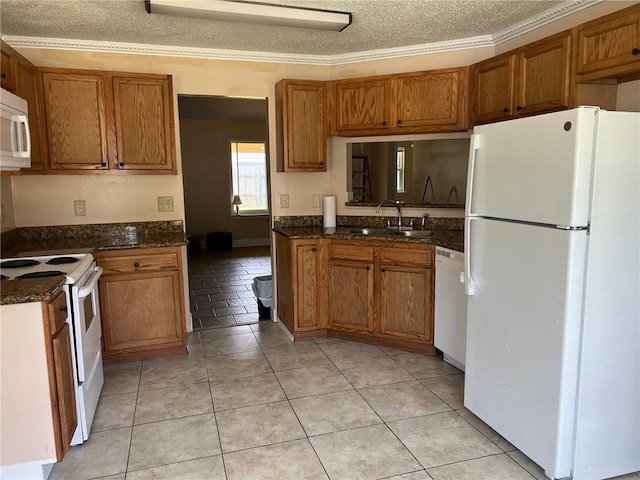 2506 S Sugar Ridge Dr, La Place, LA 70068 - kitchen featuring white appliances, a sink, brown cabinets, a textured ceiling, and light tile patterned floors