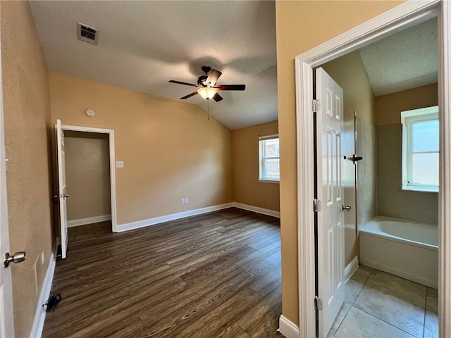 2506 S Sugar Ridge Dr, La Place, LA 70068 - unfurnished bedroom featuring lofted ceiling, dark wood-style floors, baseboards, a textured ceiling, and ceiling fan