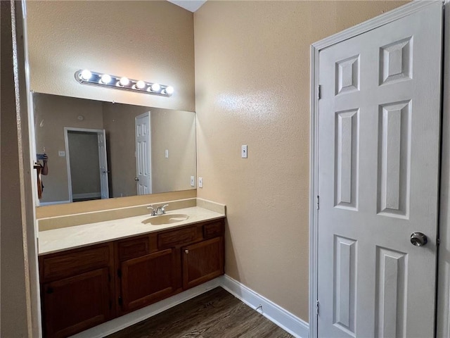 2506 S Sugar Ridge Dr, La Place, LA 70068 - bathroom featuring vanity, wood finished floors, and baseboards