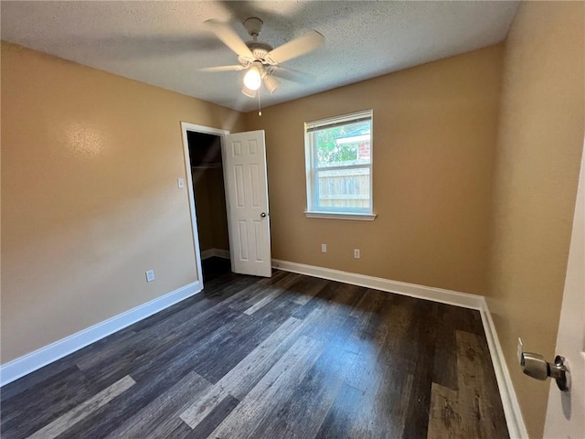 2506 S Sugar Ridge Dr, La Place, LA 70068 - unfurnished bedroom featuring dark wood-type flooring, baseboards, ceiling fan, and a textured ceiling