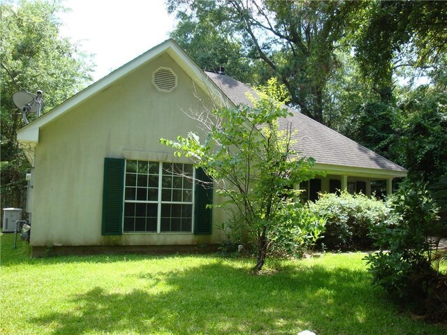 20282 Florence St, Covington, LA 70435 - back of property with roof with shingles, a lawn, and central AC