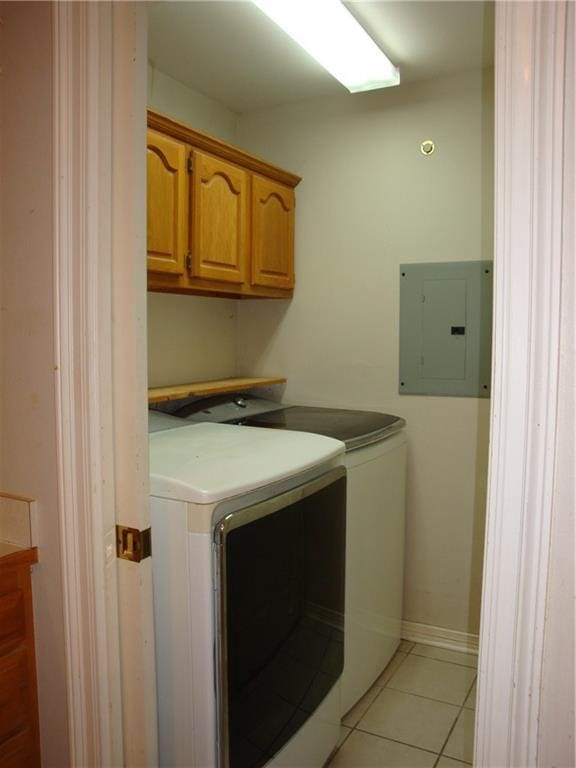 20282 Florence St, Covington, LA 70435 - laundry room with electric panel, washing machine and dryer, cabinet space, and light tile patterned floors