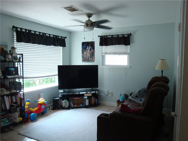 824 Oak Ave, Harahan, LA 70123 - living room with tile patterned floors, ceiling fan, and baseboards