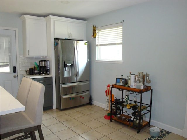 824 Oak Ave, Harahan, LA 70123 - kitchen featuring stainless steel refrigerator with ice dispenser, white cabinets, light countertops, and light tile patterned flooring
