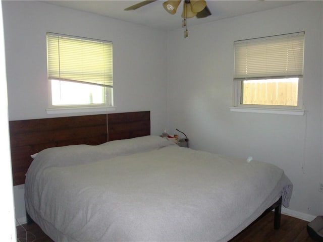 824 Oak Ave, Harahan, LA 70123 - bedroom featuring dark wood-style flooring, a ceiling fan, and baseboards