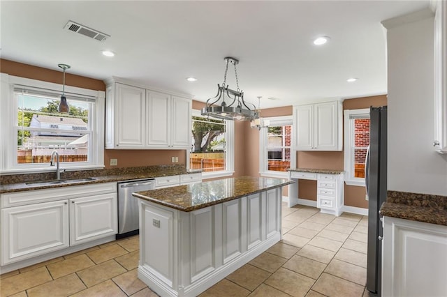 6141 Canal Blvd, New Orleans, LA 70124 - kitchen featuring stainless steel appliances, a sink, white cabinets, light tile patterned floors, and recessed lighting