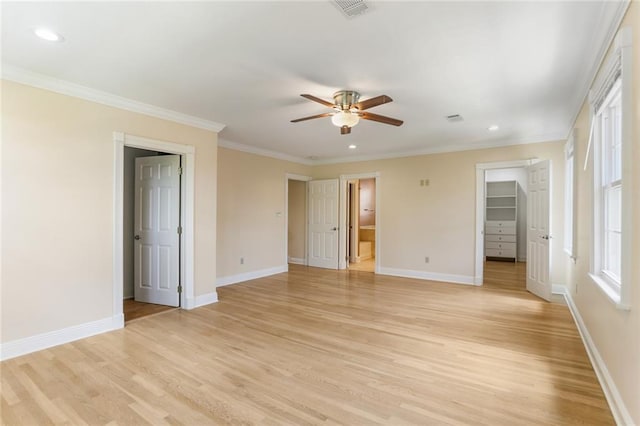 6141 Canal Blvd, New Orleans, LA 70124 - unfurnished bedroom with light wood finished floors, crown molding, baseboards, recessed lighting, and a walk in closet