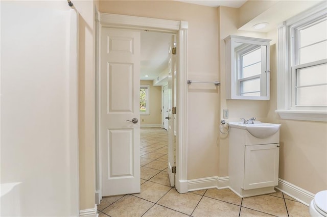 6141 Canal Blvd, New Orleans, LA 70124 - bathroom with vanity, tile patterned floors, baseboards, and toilet