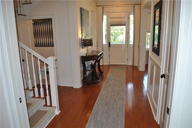 6925 Canal Blvd, New Orleans, LA 70124 - entryway with dark wood-style floors, stairway, and a decorative wall