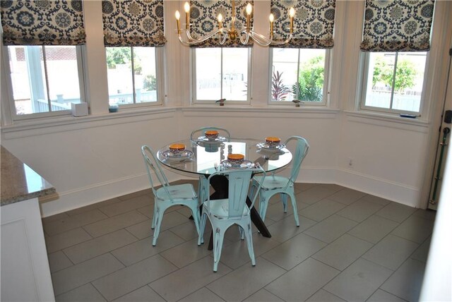 6925 Canal Blvd, New Orleans, LA 70124 - kitchen with a chandelier, beverage cooler, a center island with sink, light tile patterned floors, and tasteful backsplash