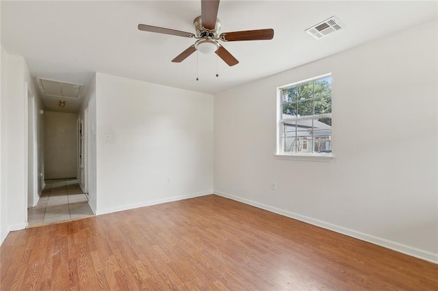 811 Tricou St, New Orleans, LA 70117 - spare room featuring attic access, light wood-style flooring, baseboards, and ceiling fan