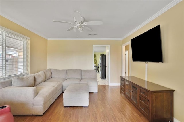 1517 Frankel Ave, Metairie, LA 70003 - living room featuring light wood-style floors, ornamental molding, a ceiling fan, and baseboards