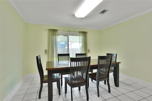 1517 Frankel Ave, Metairie, LA 70003 - dining room with ornamental molding, baseboards, and light tile patterned floors