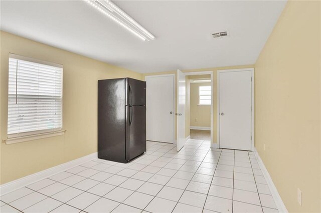 1517 Frankel Ave, Metairie, LA 70003 - kitchen with freestanding refrigerator, baseboards, and light tile patterned floors