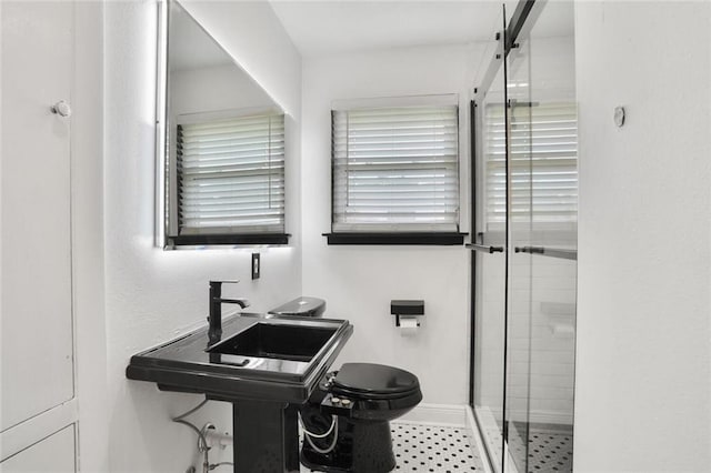 1517 Frankel Ave, Metairie, LA 70003 - bathroom featuring a stall shower, toilet, and baseboards