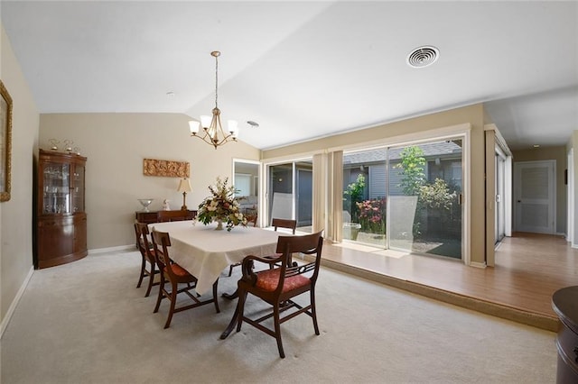 5705 Lafreniere St, Metairie, LA 70003 - dining space featuring a chandelier, baseboards, vaulted ceiling, and light colored carpet