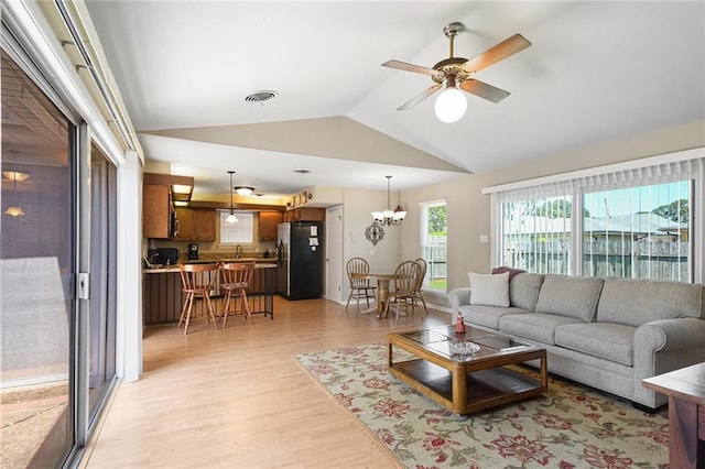 5705 Lafreniere St, Metairie, LA 70003 - living room featuring lofted ceiling, light wood-type flooring, a ceiling fan, and a chandelier