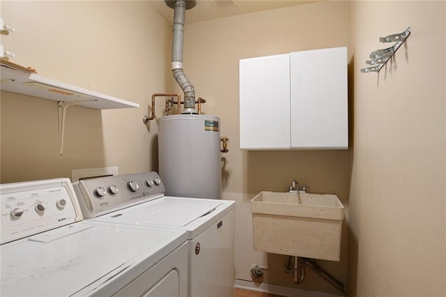 5705 Lafreniere St, Metairie, LA 70003 - laundry room with water heater, washing machine and dryer, and cabinet space