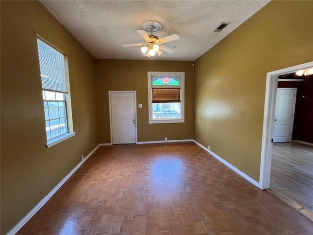 320 De Armas St, New Orleans, LA 70114 - empty room featuring a textured ceiling, healthy amount of natural light, a ceiling fan, and baseboards