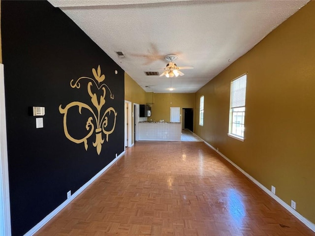 320 De Armas St, New Orleans, LA 70114 - unfurnished living room featuring baseboards, a ceiling fan, and a textured ceiling