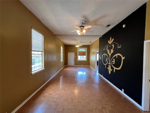 320 De Armas St, New Orleans, LA 70114 - unfurnished room featuring a textured ceiling, baseboards, healthy amount of natural light, and a ceiling fan