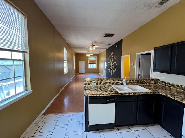 320 De Armas St, New Orleans, LA 70114 - kitchen featuring a sink, dishwasher, open floor plan, a textured ceiling, and dark cabinets