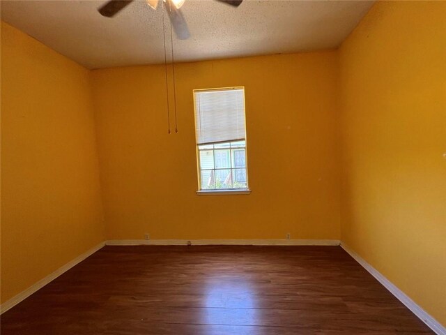 320 De Armas St, New Orleans, LA 70114 - empty room with dark wood-type flooring, a ceiling fan, baseboards, and a textured ceiling