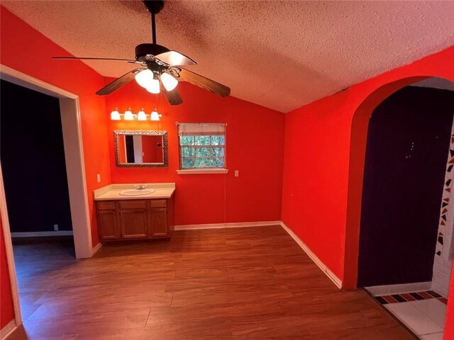 320 De Armas St, New Orleans, LA 70114 - bathroom featuring a ceiling fan, wood finished floors, vanity, a textured ceiling, and lofted ceiling