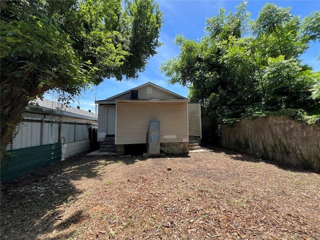 320 De Armas St, New Orleans, LA 70114 - back of house with entry steps and a fenced backyard