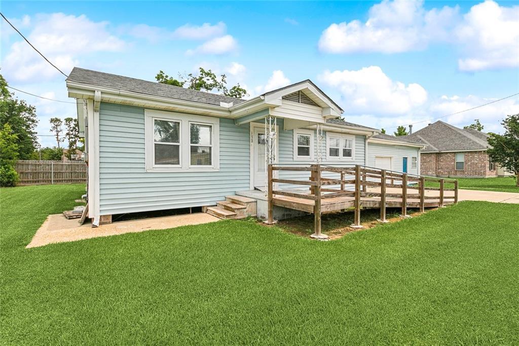 172 Elm St, Hahnville, LA 70057 - rear view of property with a wooden deck, a shingled roof, and a garage