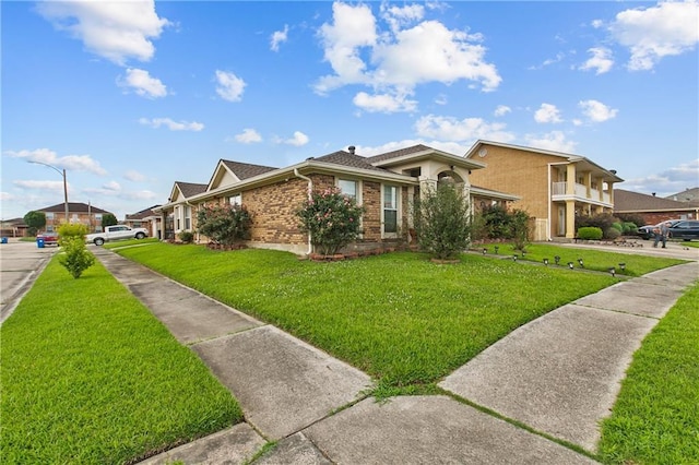11276 Fernley Dr, New Orleans, LA 70128 - view of home's exterior with a lawn and brick siding