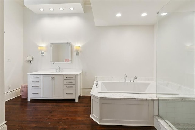 1633 Dufossat St, New Orleans, LA 70115 - full bathroom with vanity, a garden tub, wood finished floors, and recessed lighting