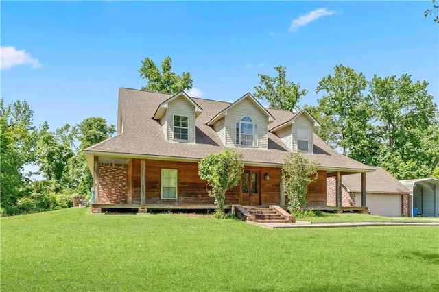 25766 La Highway 1032, Denham Springs, LA 70726 - view of front facade featuring covered porch, a detached carport, a front lawn, and roof with shingles