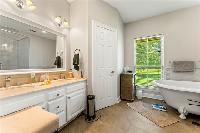 25766 La Highway 1032, Denham Springs, LA 70726 - bathroom featuring a freestanding bath, double vanity, and a shower with door
