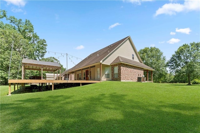 25766 La Highway 1032, Denham Springs, LA 70726 - back of house with a lawn, brick siding, and central AC