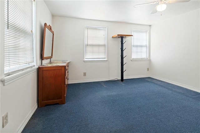 401 Oak Ave, Harahan, LA 70123 - unfurnished bedroom with dark carpet, baseboards, and a ceiling fan