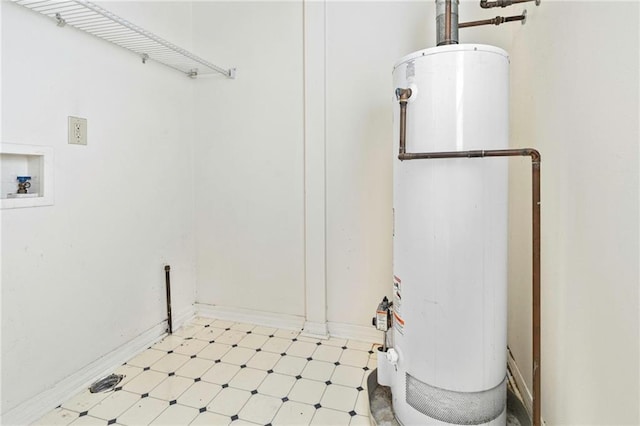 401 Oak Ave, Harahan, LA 70123 - laundry area featuring gas water heater, light floors, and baseboards