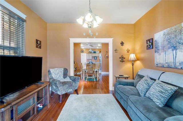 2622 Wisteria St, New Orleans, LA 70122 - living room featuring a chandelier, wood finished floors, a ceiling fan, and baseboards