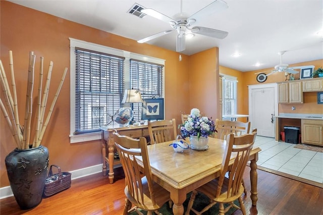 2622 Wisteria St, New Orleans, LA 70122 - dining area with ceiling fan, baseboards, and light wood-style floors