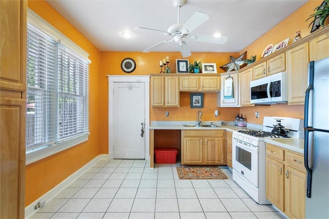 2622 Wisteria St, New Orleans, LA 70122 - kitchen with white appliances, a sink, a ceiling fan, and light countertops