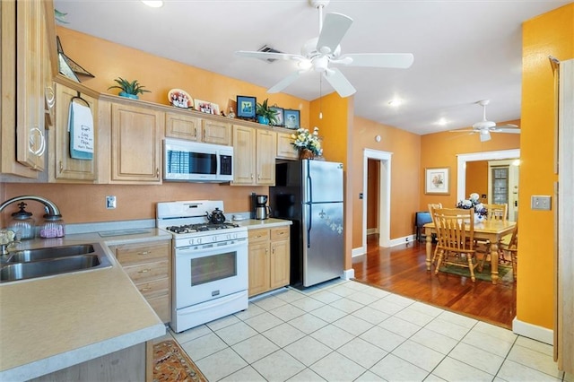 2622 Wisteria St, New Orleans, LA 70122 - kitchen featuring white appliances, a sink, ceiling fan, light countertops, and light brown cabinets