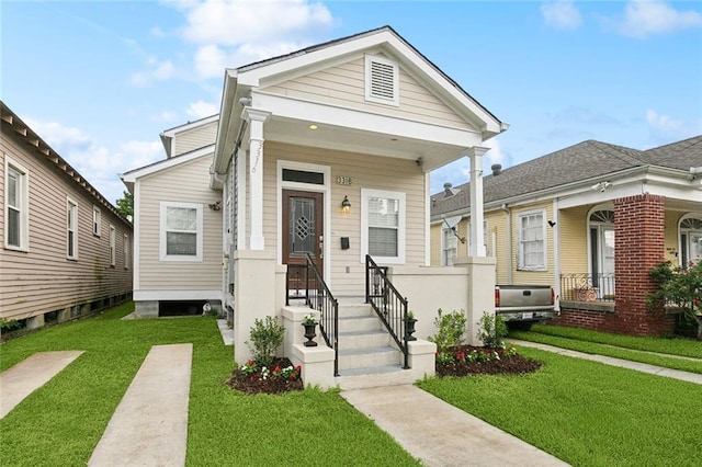3316 Calhoun St, New Orleans, LA 70125 - shotgun-style home with a front lawn and a porch